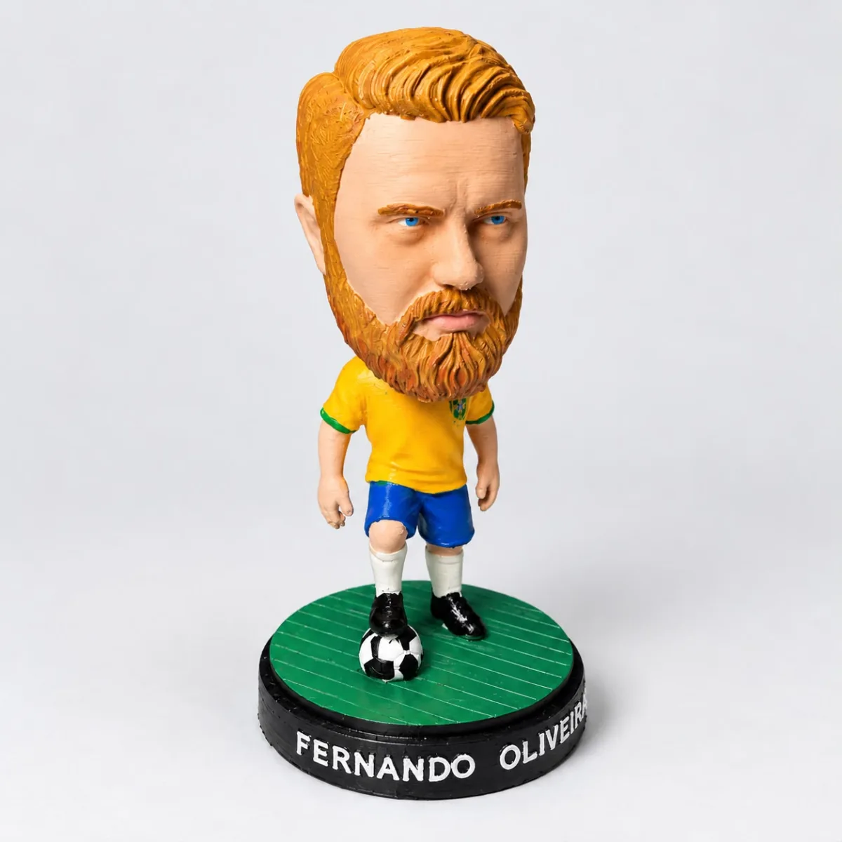 Boneco cabeçudo ruivo de barba com camisa amarela do Brasil e o nome Fernando na base